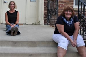 2 women sitting on steps