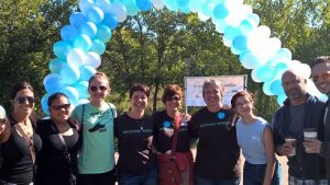 10 people standing in front of balloon arch outside at the 2015 Walk for Recovery