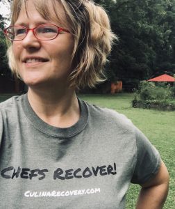 Woman wearing a "Chefs Recover" t-shirt