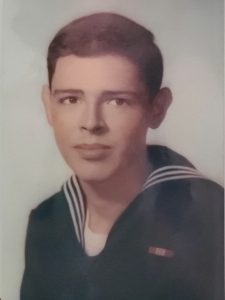 Young man in U.S. Navy uniform.