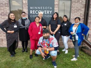8 people standing in front of Minnesota Recovery Connection